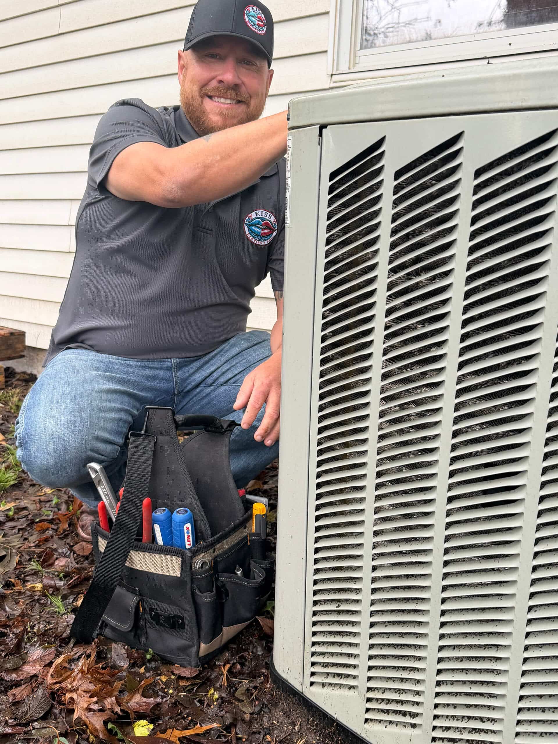 Brandon McBee servicing an outdoor HVAC unit